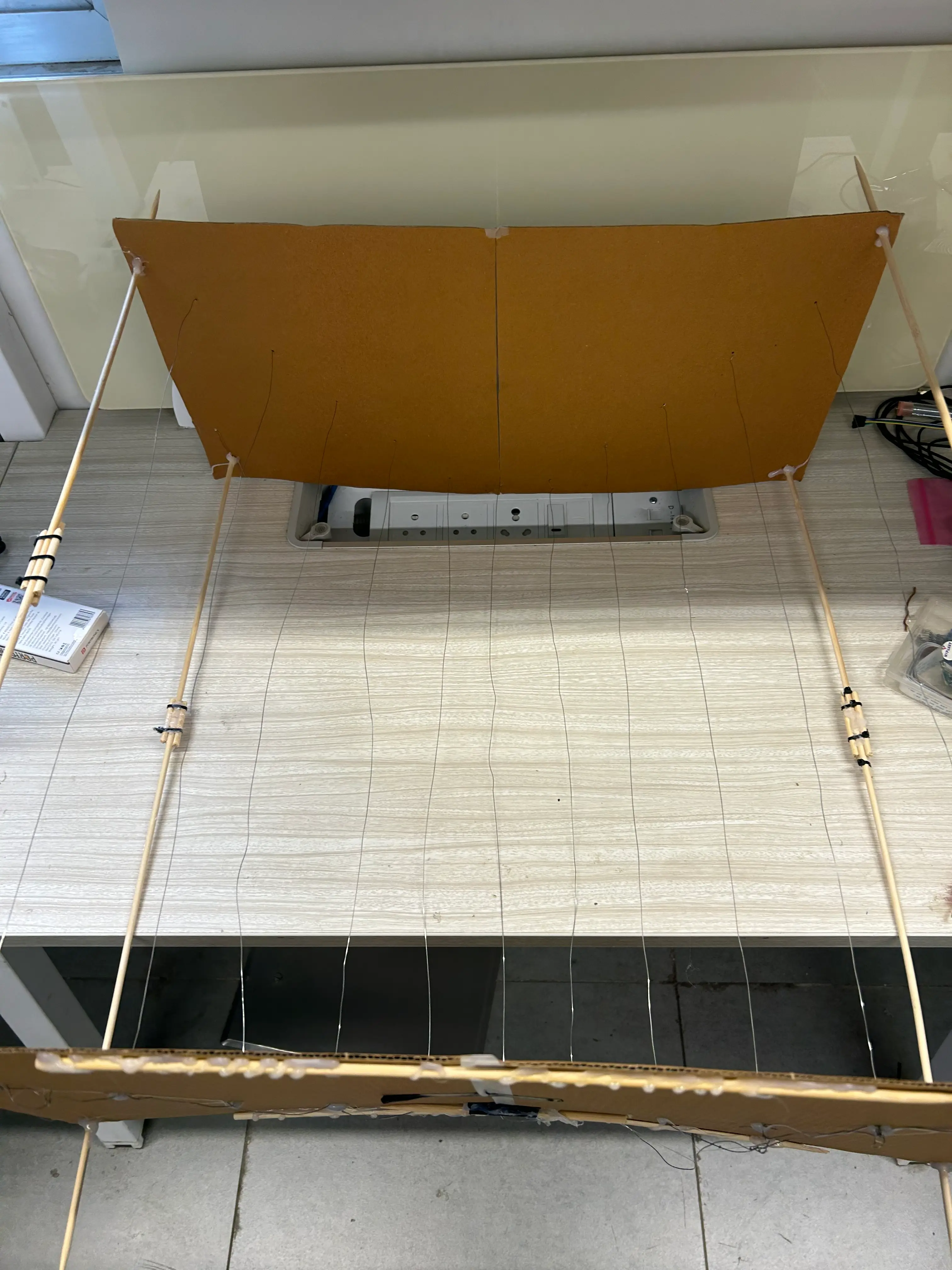 Bones of the parabolic dish made by hand using cardboard and wooden sticks and equations