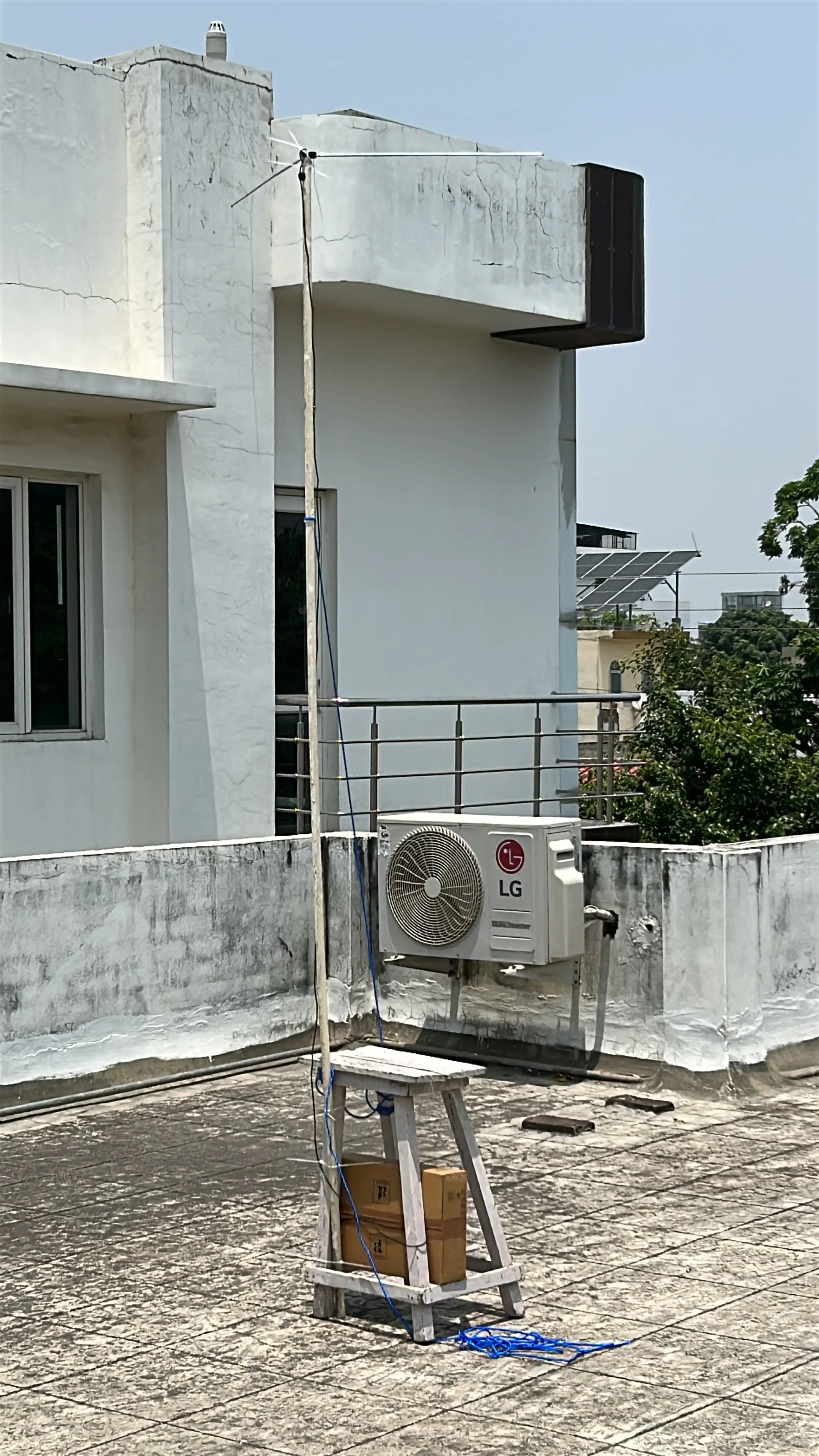 Dipole antenna mounted on a PVC pole tied to a wooden stool on my lucknow roof