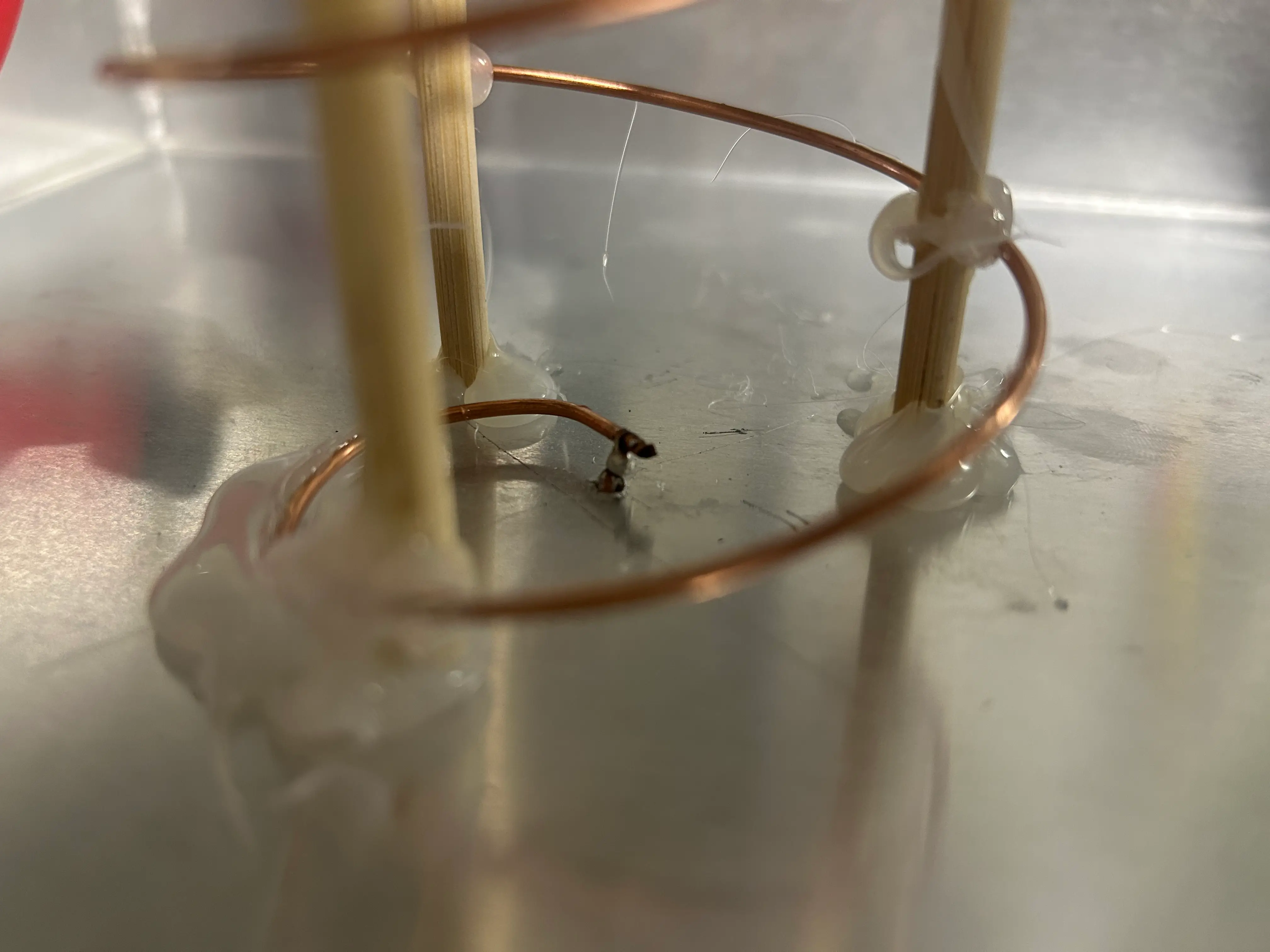 Zoom in of the helix soldered onto the aluminium reflector plate i made from a pizza tray - helix wooden supports and soldered feed point visible